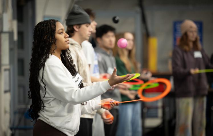Myla juggling in the forefront