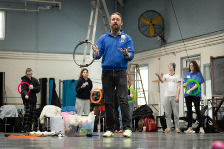 Visiting instructor explaining in with hoops in his hands