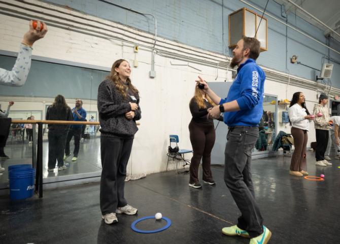 Visiting instructor talking to one student