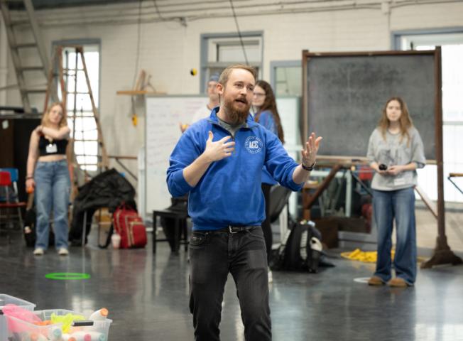 Visiting instructor talking to a few students