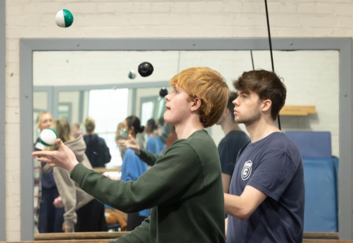 Two students juggling with success