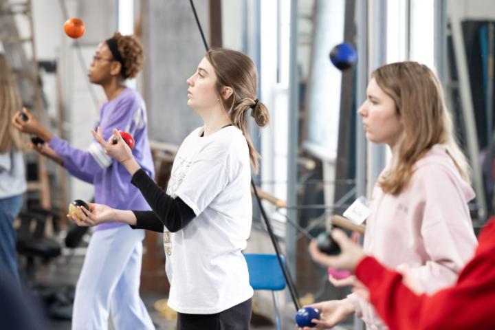 Three students focused on juggling